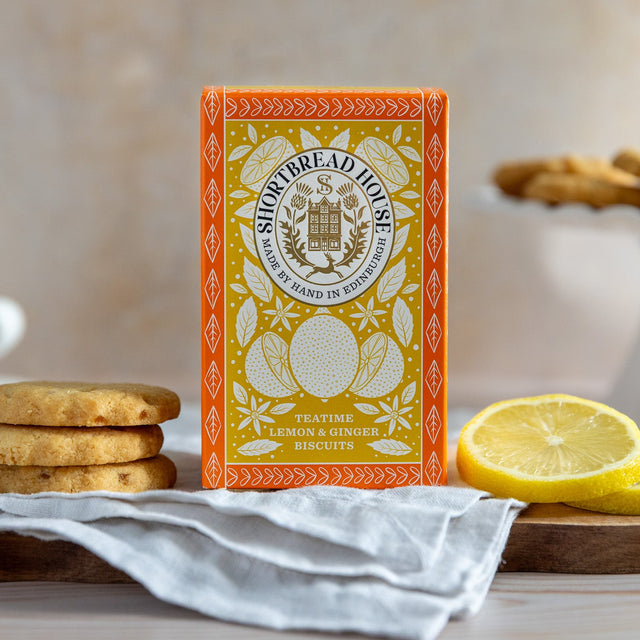 Box of Lemon and Ginger Biscuits with slices of lemon and biscuits