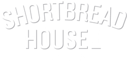 White arched 'SHORTBREAD' text above the word 'HOUSE_' in a matching light gray outline font on a white background.