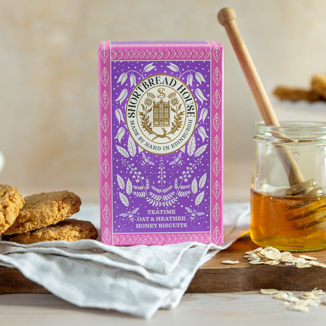 Sweet Oaties on a wooden board with biscuits and a jar of honey