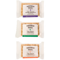 Three packages of Shortbread House of Edinburgh shortbread biscuits in 2-finger packets on a white background