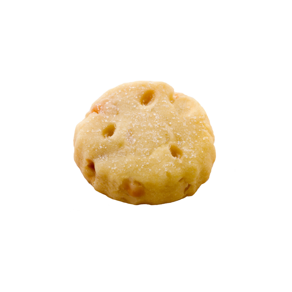 Round biscuit with small nuts on a white background