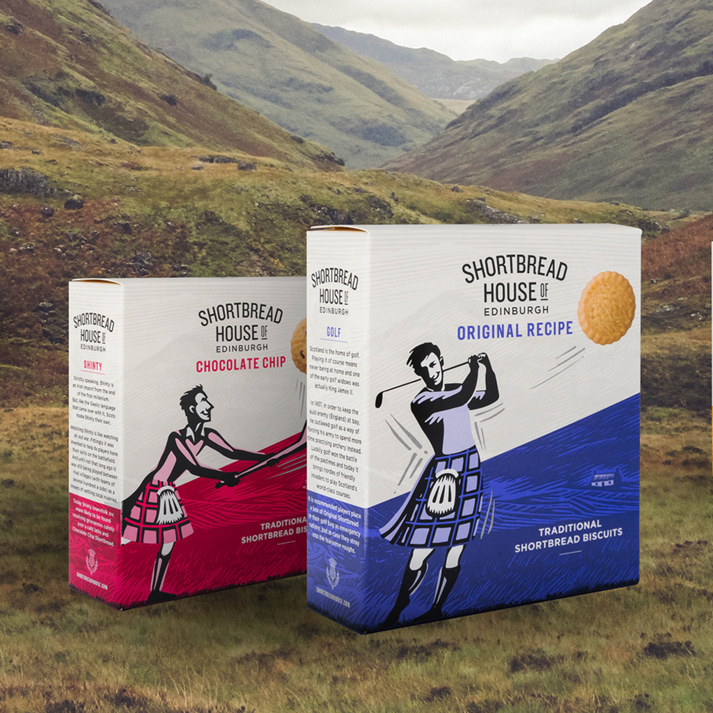 Two boxes of Shortbread House of Edinburgh shortbread biscuits with a scenic background.