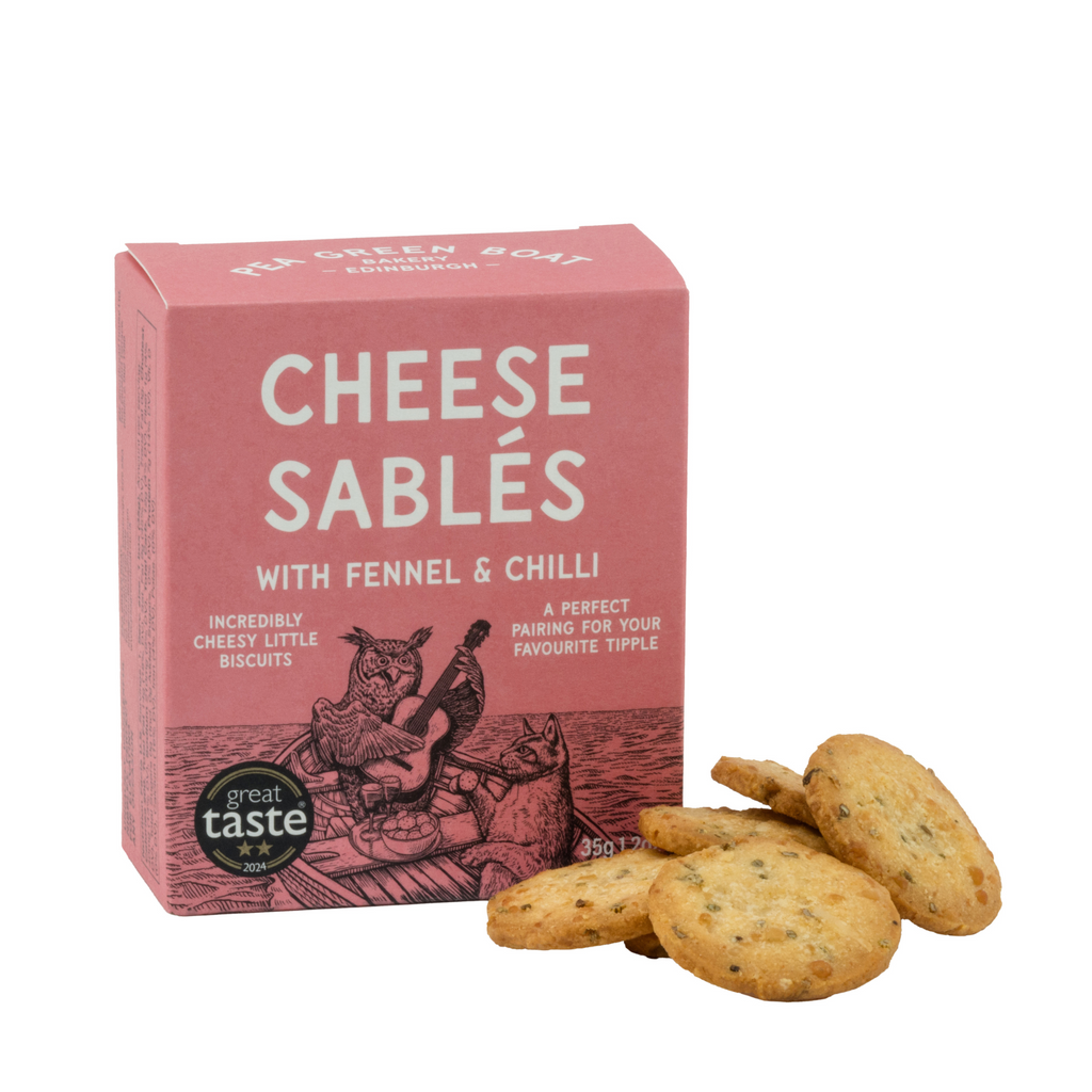 Small red box of Fennel & Chilli Cheese Sables with biscuits stacked to the side.