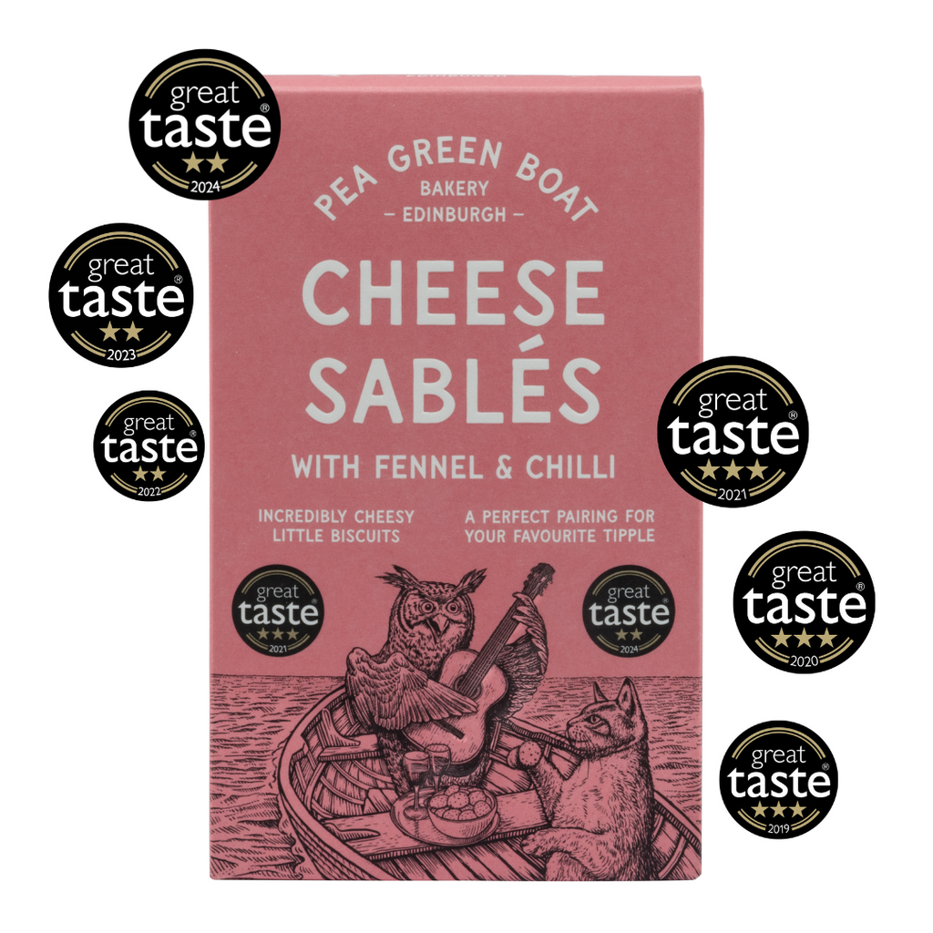 Red box of Fennel and Chilli Cheese Sables with 6 Great Taste Awards surrounding it. 