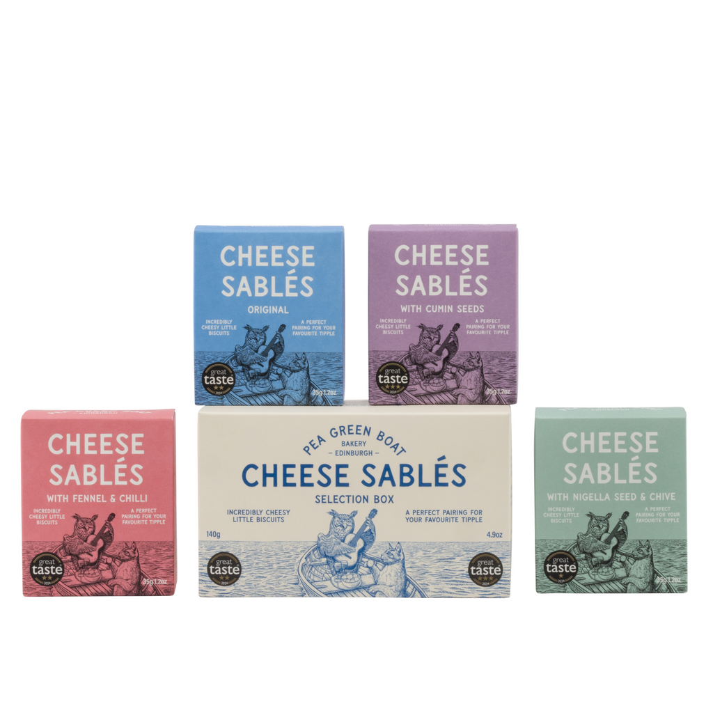 White Selection box of cheese sables with 4 small boxes around it for the 4 flavours. 