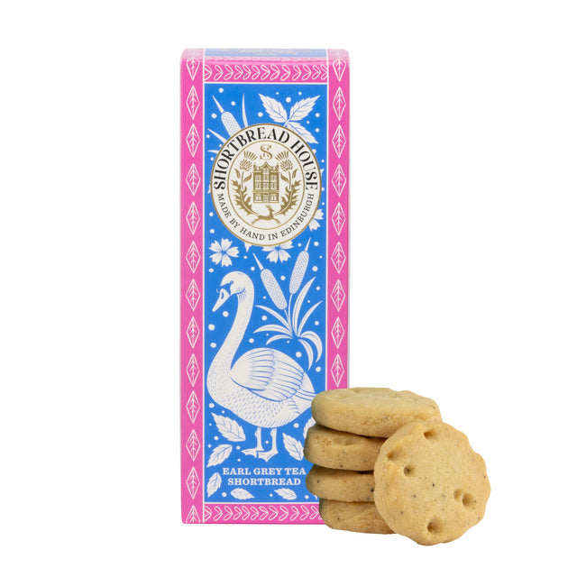 Shortbread House Earl Grey Tea Shortbread cookies displayed in front of their blue and pink illustrated packaging box, featuring a swan design and gold crest.