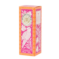 A rectangular box of Shortbread House Macadamia Nut Shortbread, featuring a vibrant pink and orange design with white illustrations of a parrot and leaves.