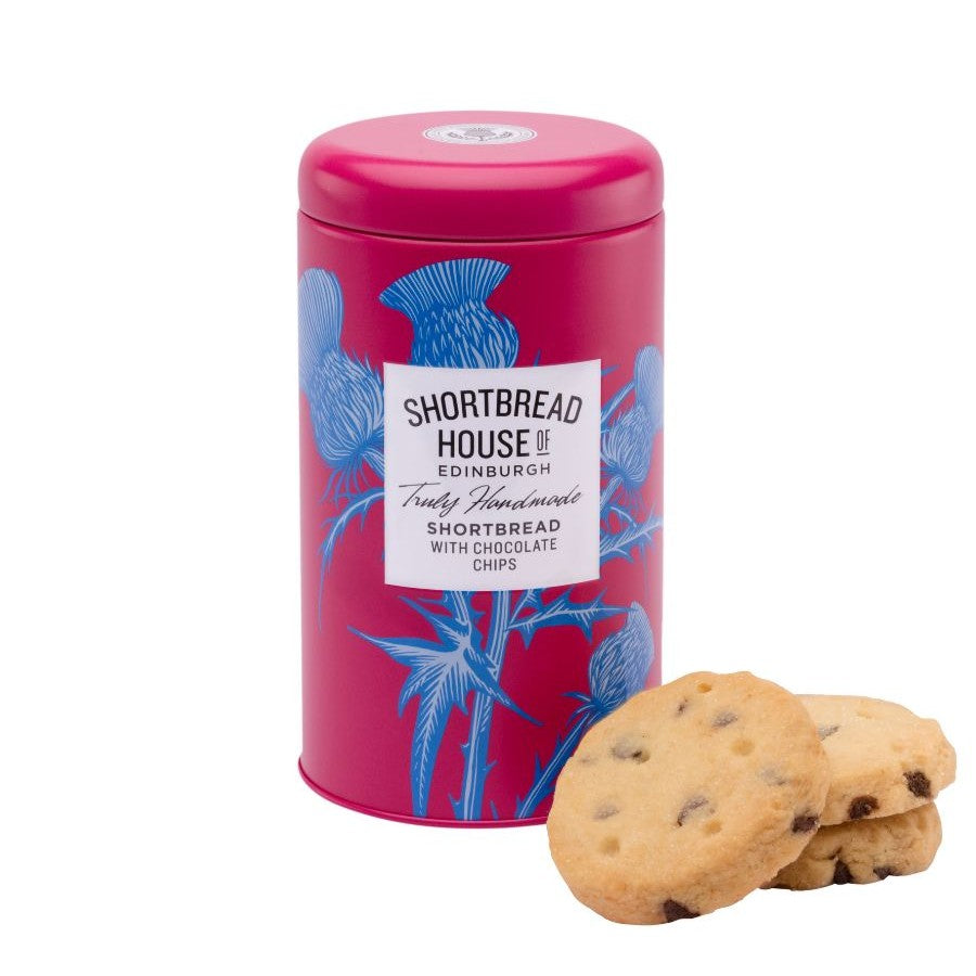 Pink tin of Shortbread House of Edinburgh shortbread with chocolate chips, accompanied by biscuits on a white background.