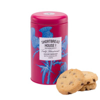 Pink tin of Shortbread House of Edinburgh shortbread with chocolate chips, accompanied by biscuits on a white background.