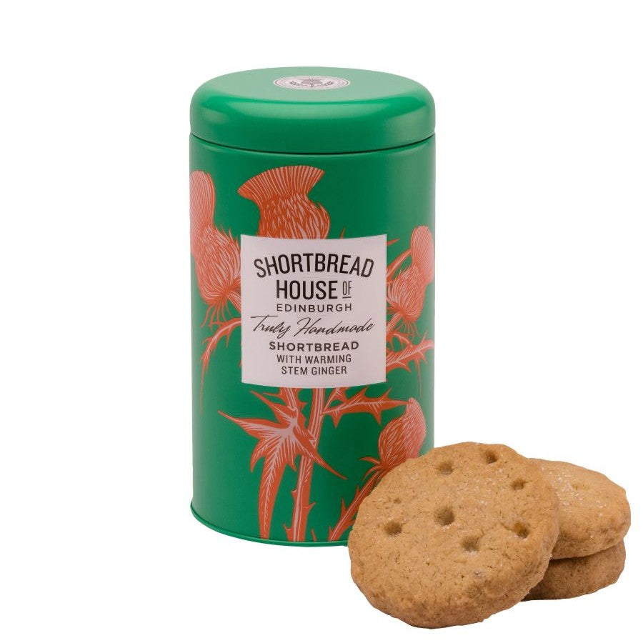 Green tin of Shortbread House of Edinburgh shortbread with ginger, accompanied by 3 cookies on a white background.