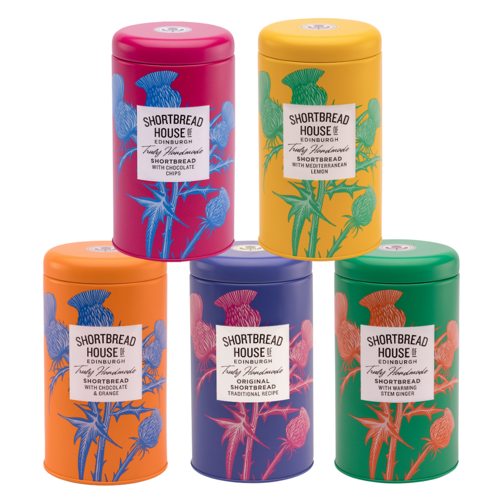 Five colorful shortbread tins of Shortbread House shortbread biscuits with thistle design.