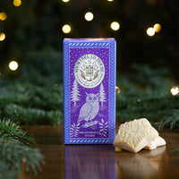 Purple Box of Shortbread Stars with Owl Design amongst Fir Branches