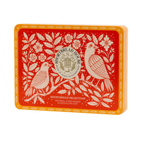 Decorative tin with bird and floral design on a red background