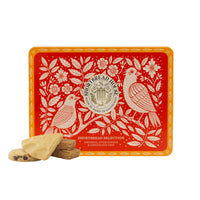 Decorative tin box with bird design and fours shortbread biscuits on a white background
