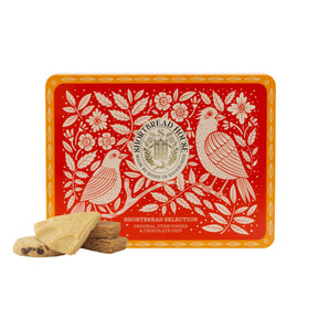 Decorative tin box with bird design and fours shortbread biscuits on a white background