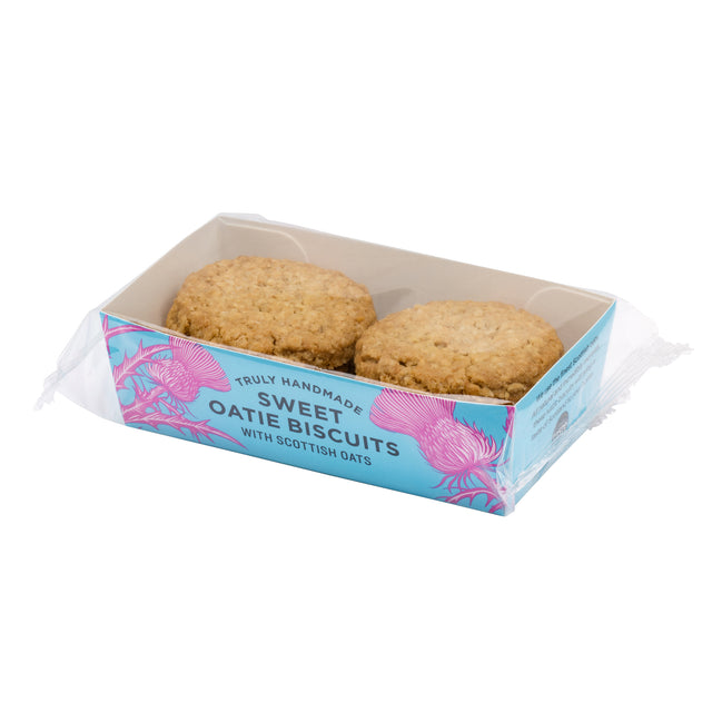 Six round oat-based sweet biscuits in a clear plastic tray with a blue and pink branded box, photographed on a white background.